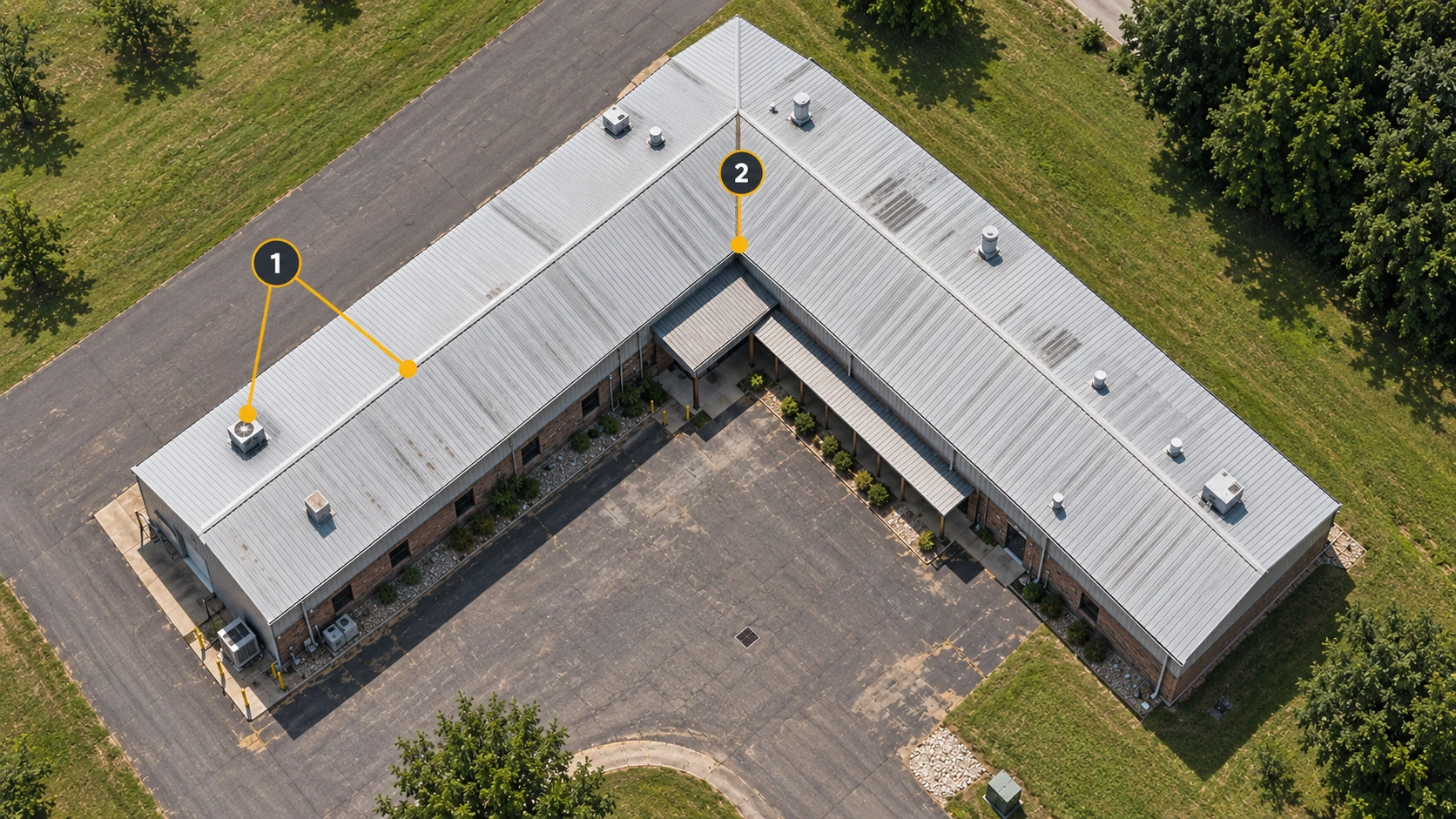 A near-overhead view of the factory: 1 marks a ridge and rooftop features; 2 marks the junction of the two wings.