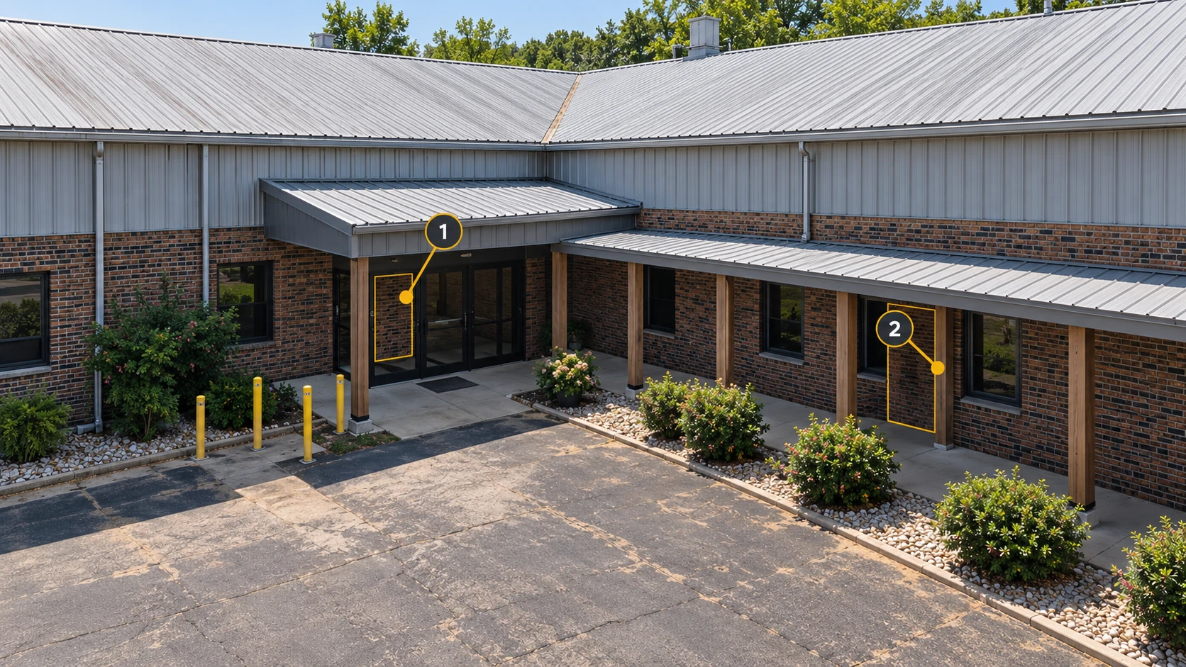 The factory entrance and covered walkway: 1 marks the wall beneath the canopy; 2 marks a recess behind walkway posts.