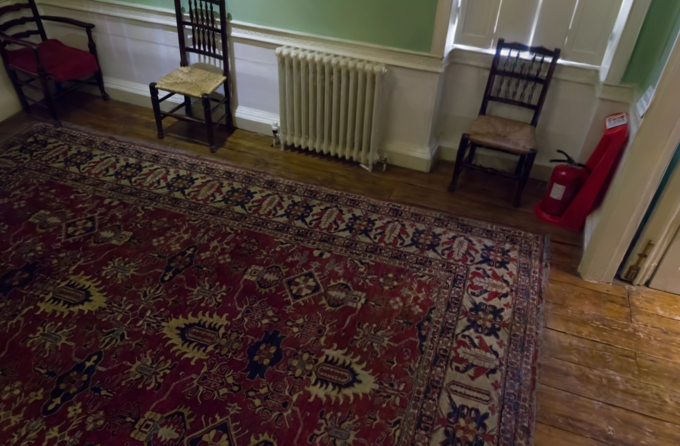 MakeWorlds render: The rug, chairs, and wooden floor in Dr Johnson