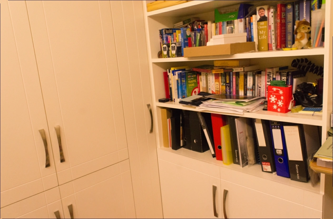 Original photograph: Bookshelves, binders, and cupboard doors in Playroom