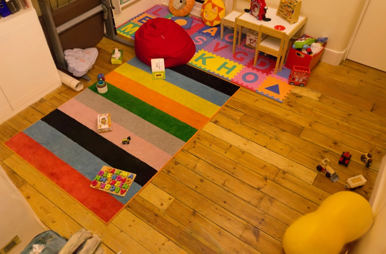 MakeWorlds render: The striped rug, toys, and wooden floor in Playroom